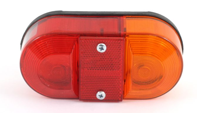 Red and orange oval light with a black top and screws, typically used for warning signals.
