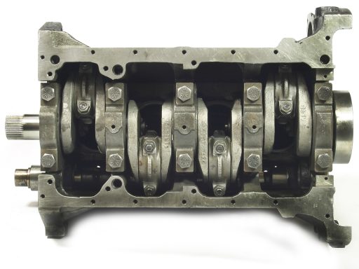 A disassembled engine block showcasing the crankshaft and connecting rods.