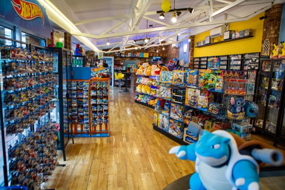 Colourful toy store aisle featuring shelves of plush toys and merchandise.