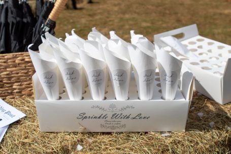 A box of decorative cones filled with confetti or flower petals, ready for use.